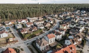 Aerial view of residential neighborhood showing a grading plan layout with proper drainage slopes around homes and fences