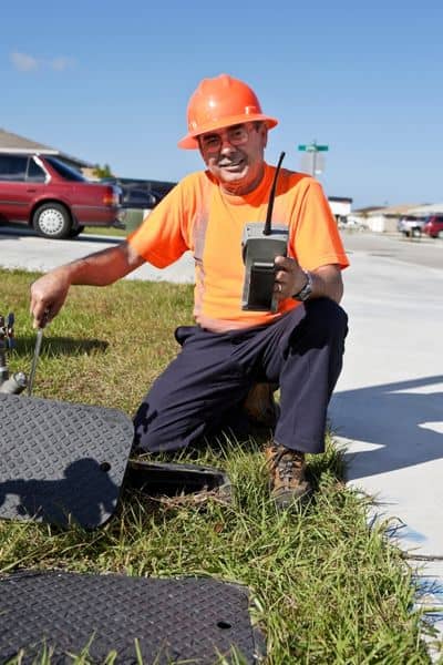 Civil engineer inspecting stormwater drainage infrastructure during a site visit