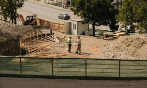 Construction site showing erosion control plan measures in place to protect soil and manage runoff during grading work