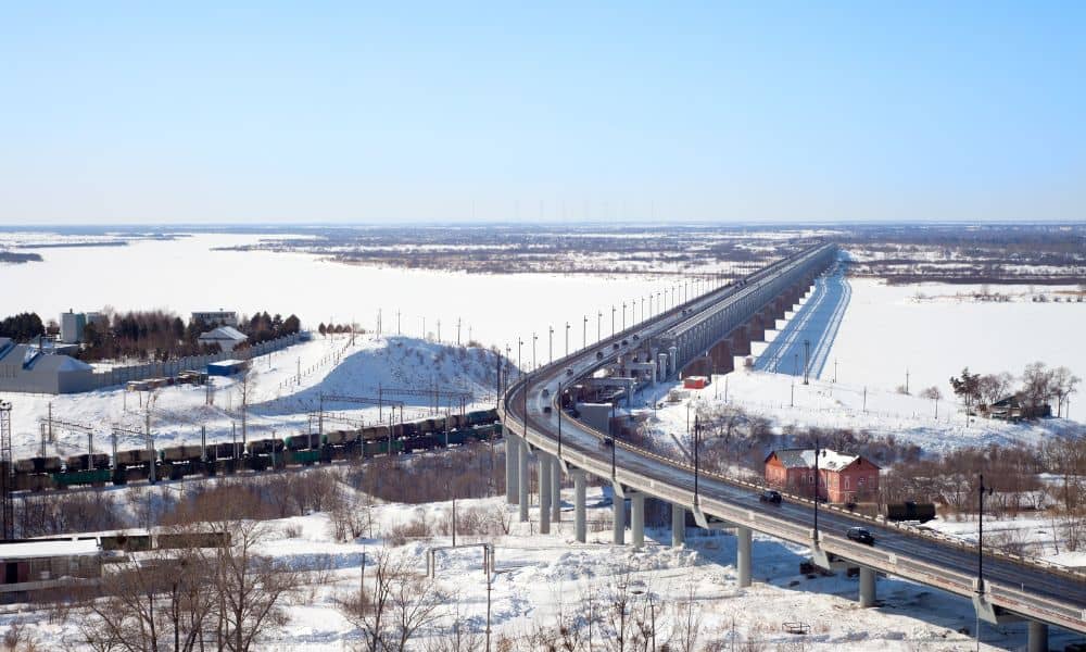 Winter bridge spanning a snowy landscape, showing how structural engineering decisions help manage safety risks in cold weather