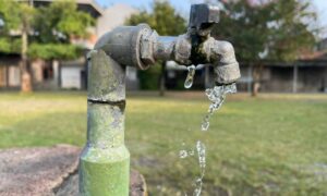 A professional engineer explains low water pressure using an example of a faucet dripping after nearby utility work