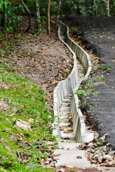 Geotechnical engineering drainage design - ALTA SURVEY Michigan Geotechnical engineering drainage design showing a concrete channel to manage stormwater flow on a landfill solar project site