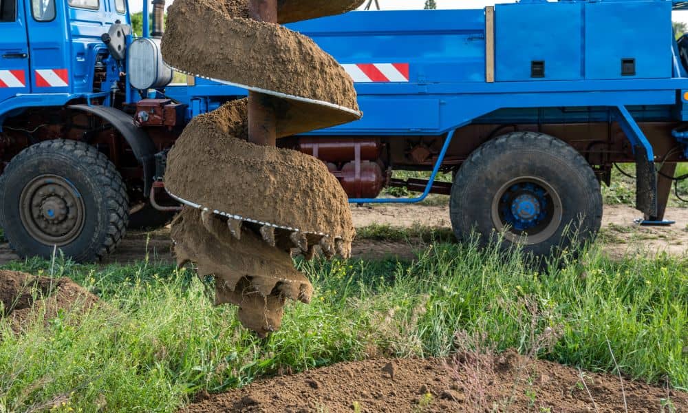 Close-up of a drilling rig auger collecting soil samples for testing before construction