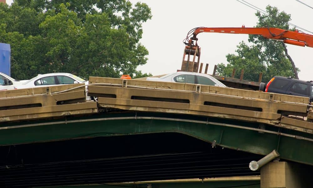 A collapsed bridge section with vehicles trapped on the roadway, showing the kind of infrastructure failures traffic engineers must respond to during major disasters