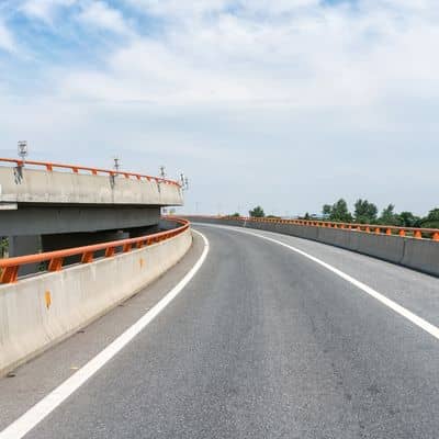 A curved highway ramp showing roadway design features that support traffic safety