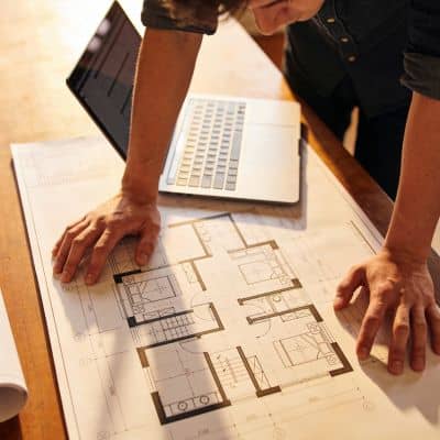 Civil engineer reviewing erosion control plan drawings to prepare for city inspection and site compliance