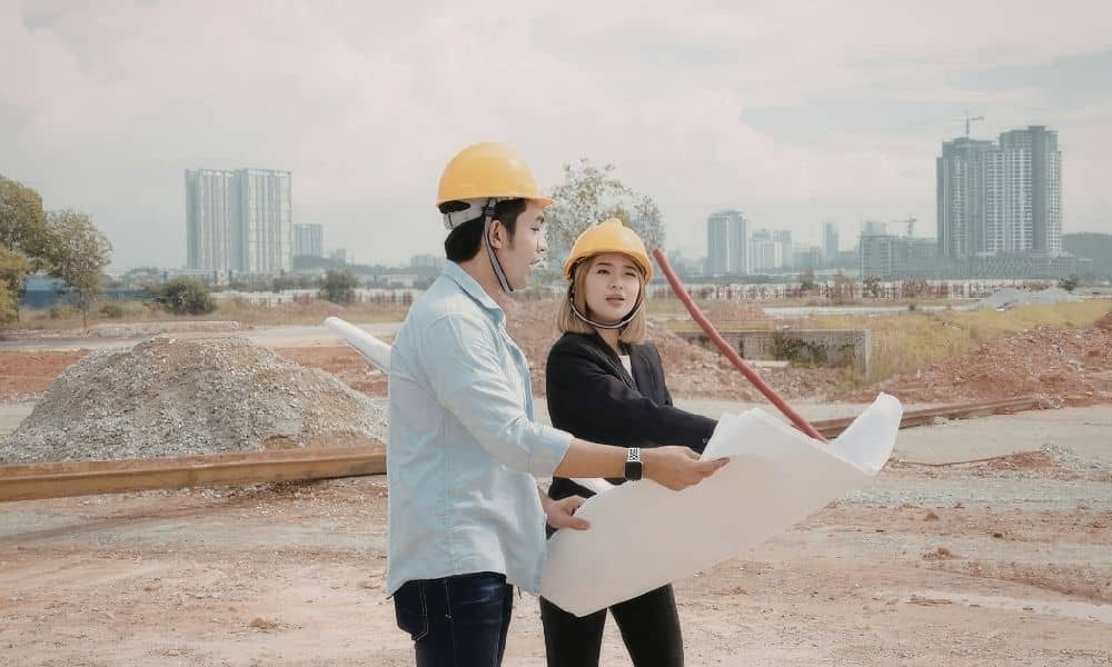 Developers reviewing site plans at a construction site during changes to land entitlements and housing policy