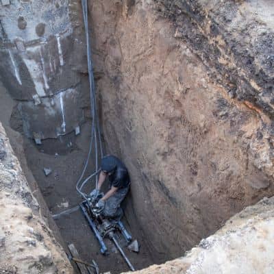 A professional engineer reviewing underground water line repairs that can cause temporary pressure changes after utility work