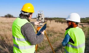 Surveyors conducting land surveys on an undeveloped property before development planning