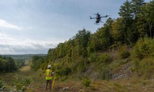 Drone lidar mapping in michigan - ALTA SURVEY Michigan A surveyor monitors drone LiDAR mapping over a wooded utility corridor in Michigan