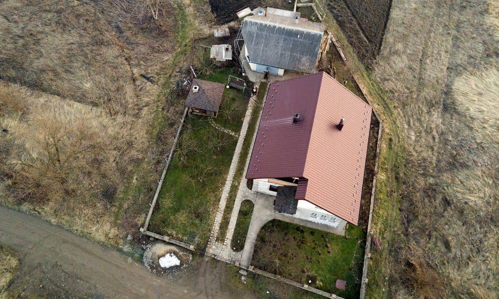 Aerial view of a residential property with a fence around the yard, showing the boundaries a boundary survey can help confirm before building a new fence
